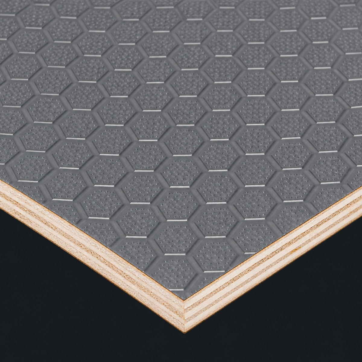 Grey hex board plywood with a textured hexagonal face and exposed layered edges. Black background.